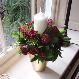 Red rose and skimmia candle decoration