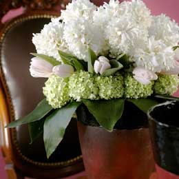 White hyacinths, tulips and guelder rose with aspidistra leaves